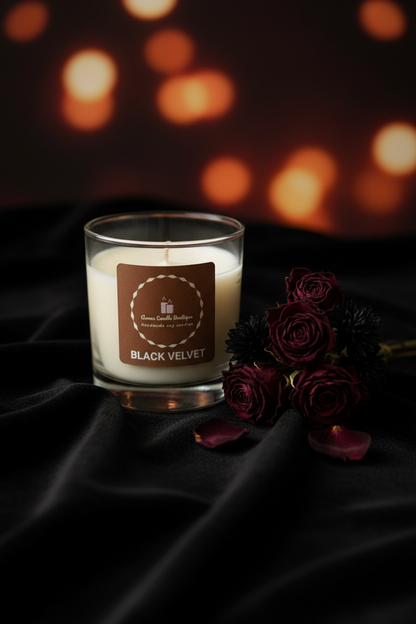 Candle labeled 'Black Velvet' with roses on a dark fabric background