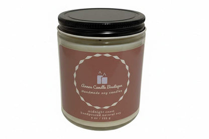 Candle in a glass jar with a black lid on a white background