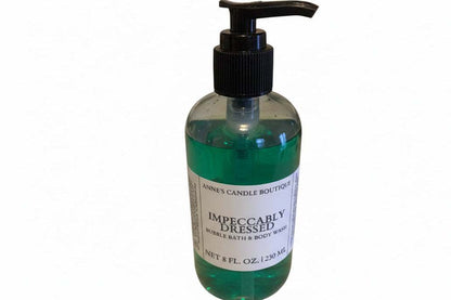 Bottle of bubble bath with a pump labeled 'Impeccably Dressed' on a white background