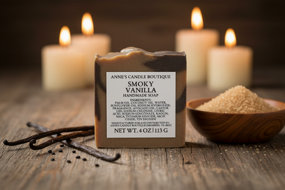 Bar of soap with a label in front of candles and a bowl of sugar on a wooden surface.