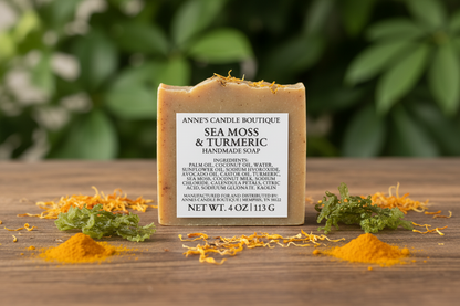 Bar of soap with a label on a wooden surface, surrounded by sea moss and turmeric, with a green leafy background.